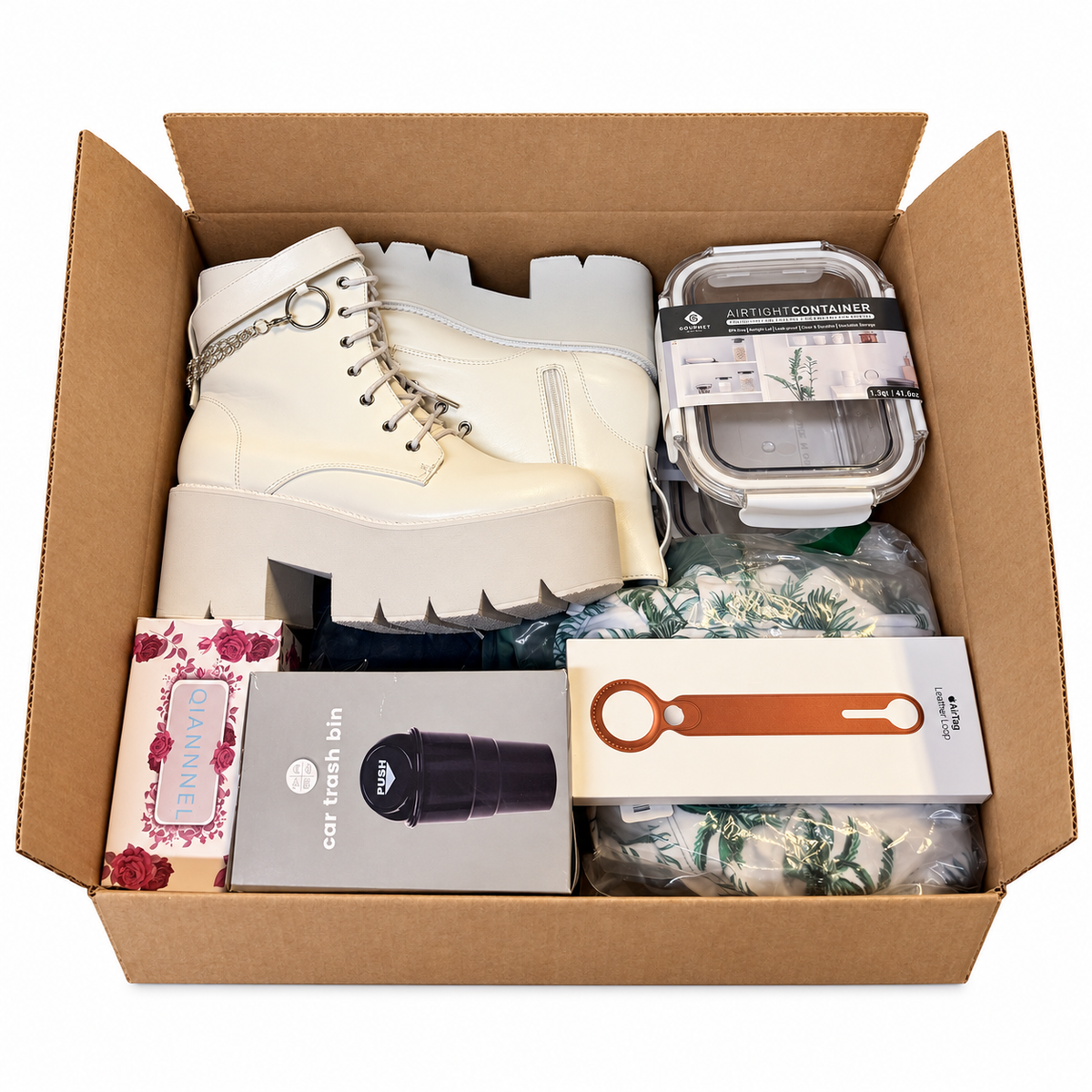 Mystery Madness box showing example new products including boots and household items; actual contents vary
