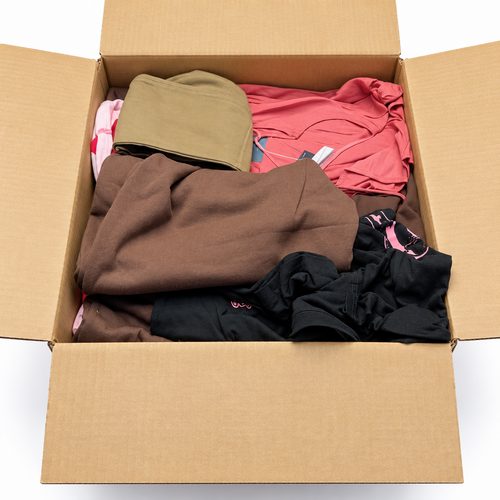 An open TGT Fashion Mystery Box showing example contents; actual contents vary